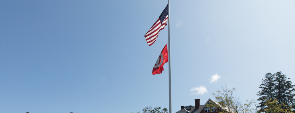 US 和 TAC flags fly over the New Engl和 campus